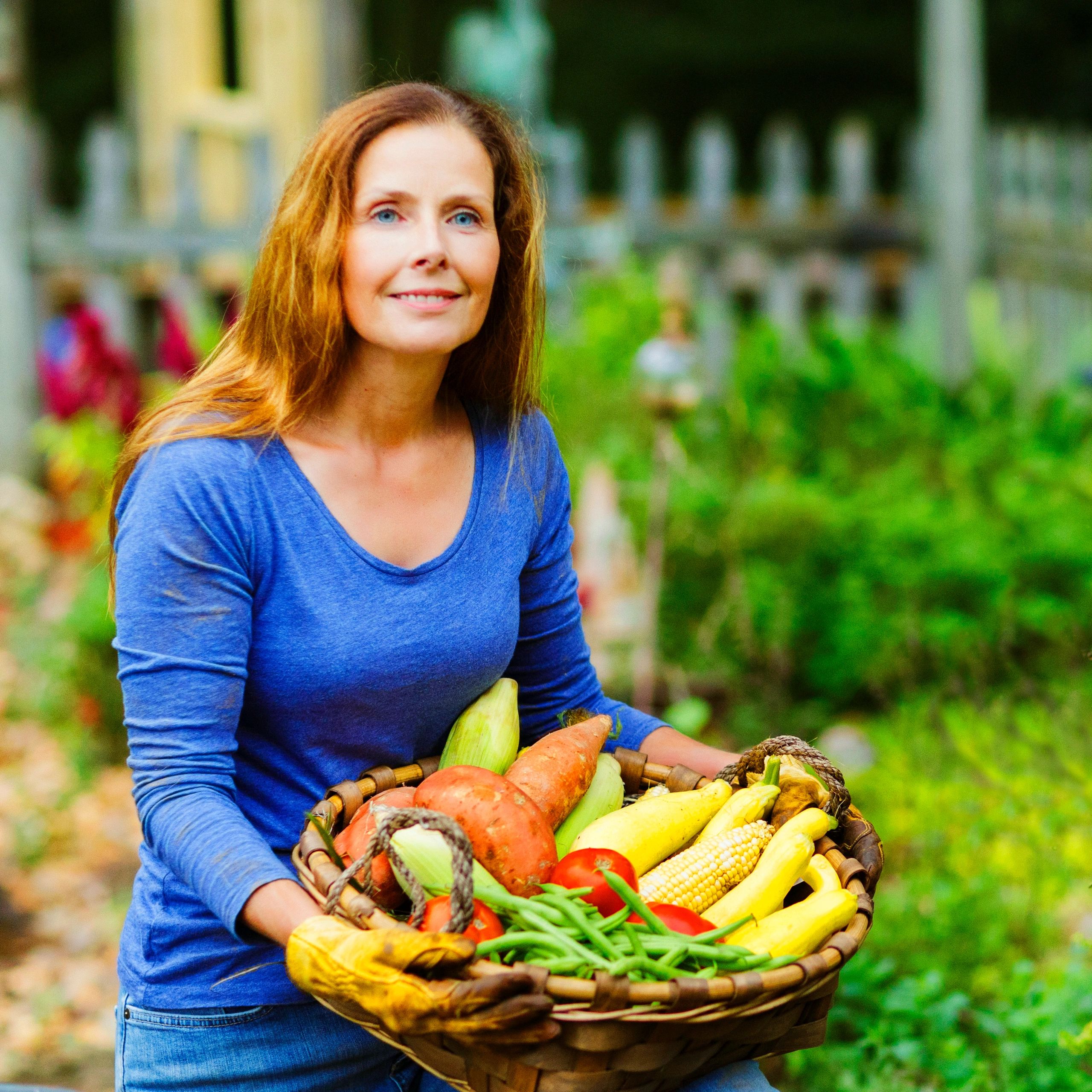 Local farm customer holding fresh garden vegetables